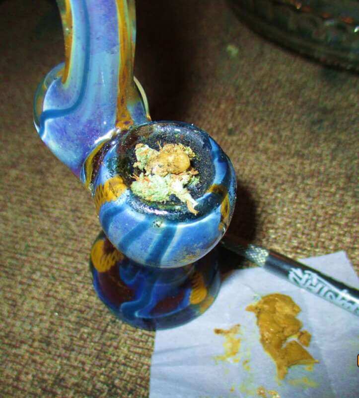 hbutter hash being placed into a bong of cannabis