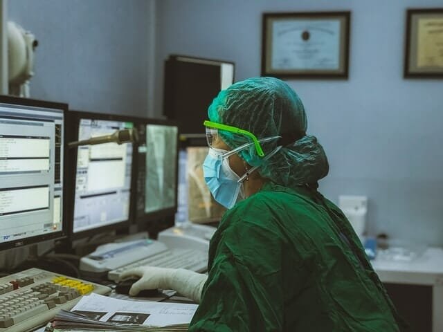 medical personnel checking graphs on computer